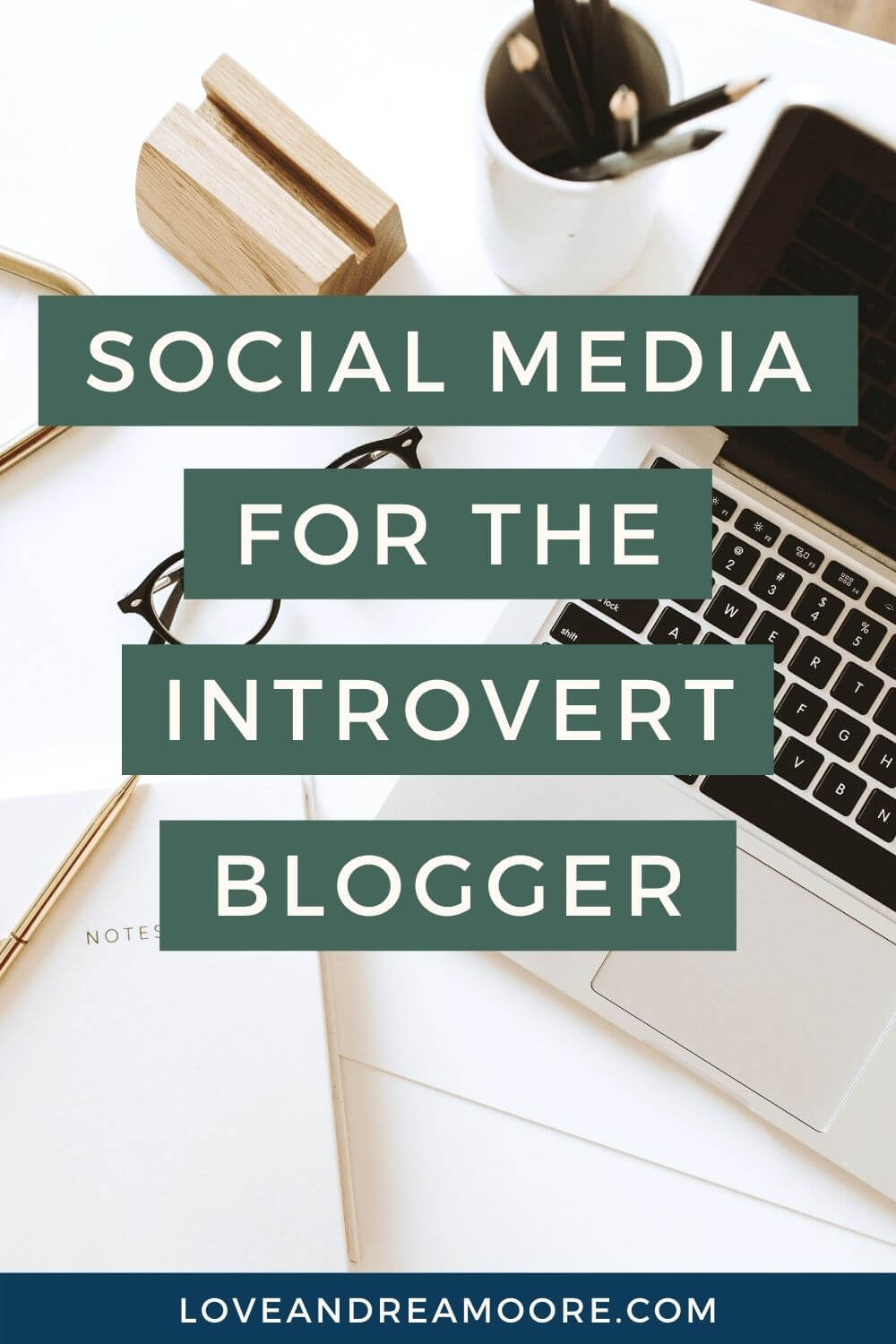 white desk with computer and office supplies with text overlay that says social media for the introvert blogger